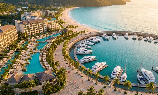 Aerial view of a beachfront tourism destination with resorts and a marina